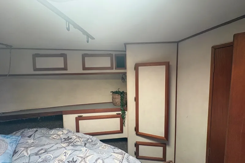 Slide: The Image of Interior cabin of 1989 Topaz 44 Sportfisherman with wood accents and storage cabinets. - 18