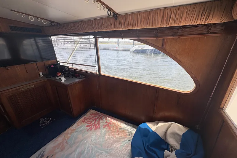 Slide: The Image of Interior of 1989 Topaz 44 Sportfisherman with wood paneling and waterfront view. - 13