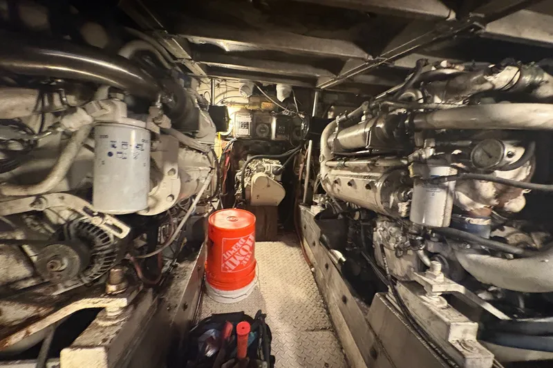Slide: The Image of Engine room of a 1989 Topaz 44 Sportfisherman with visible machinery and equipment. - 25