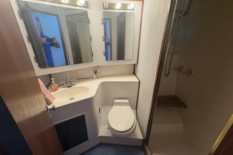 Slide: The Image of Bathroom interior of 1989 Topaz 44 Sportfisherman with shower, toilet, and mirrored cabinet. - 22