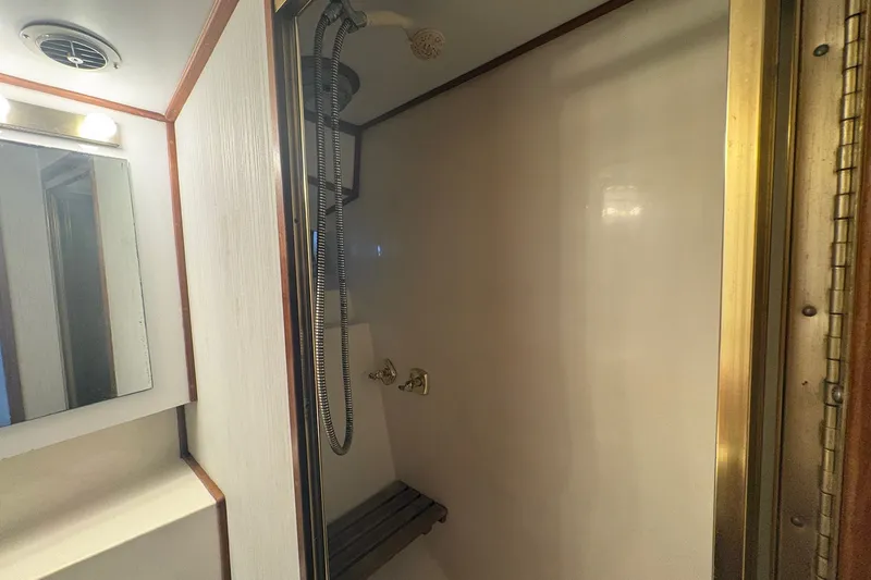 Slide: The Image of Shower area inside 1989 Topaz 44 Sportfisherman boat, featuring modern fixtures and mirror. - 21