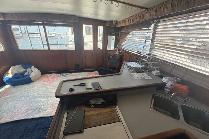 Slide: The Image of Interior of 1989 Topaz 44 Sportfisherman yacht with wooden accents and marina view. - 11