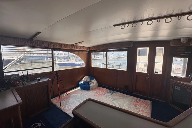 Slide: The Image of Interior of 1989 Topaz 44 Sportfisherman boat with wooden decor and marina view. - 10