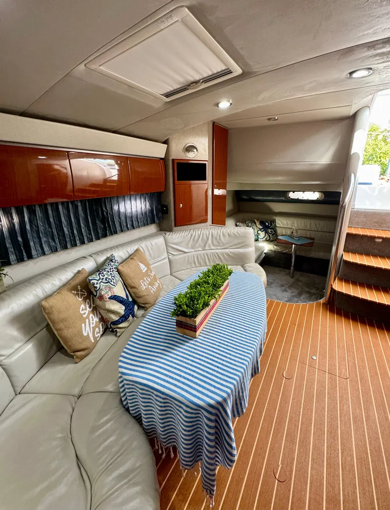 Slide: The Image of Interior of a 2006 Formula 40pc yacht with elegant seating and striped tablecloth. - 13