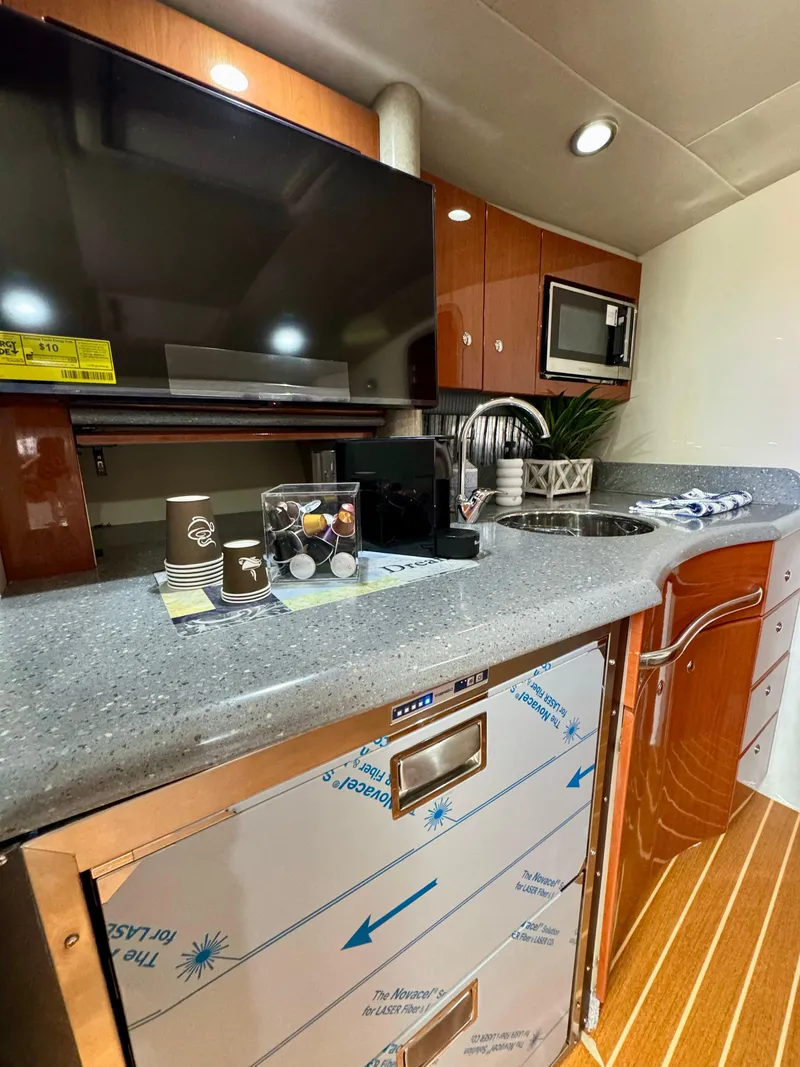 Slide: The Image of 2006 Formula 40pc yacht interior kitchen with modern appliances and sleek design. - 29