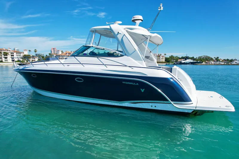 Slide: The Image of 2006 Formula 40pc yacht on clear blue water, showcasing sleek design and luxury features. - 5