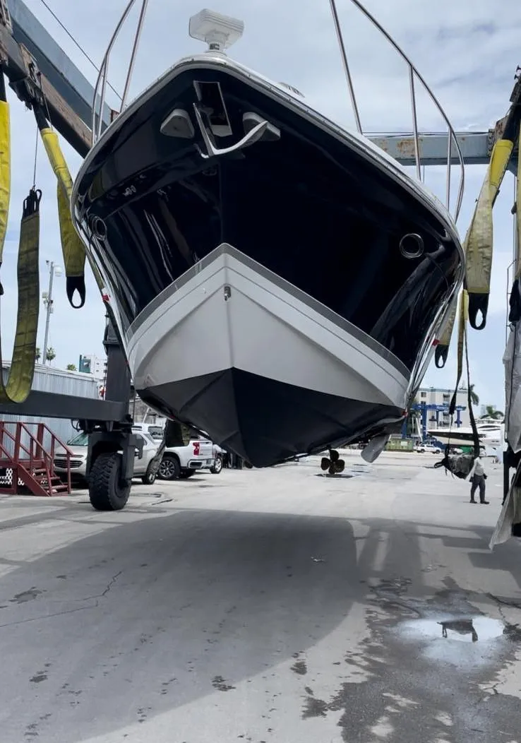 Slide: The Image of 2006 Formula 40pc boat being lifted at a marina. - 39