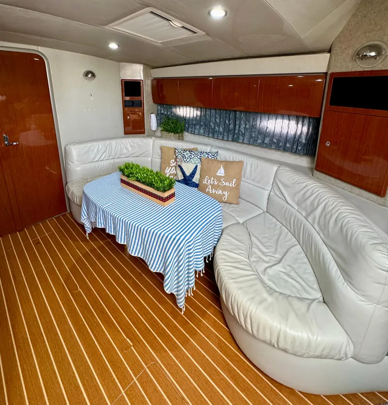 Slide: The Image of Luxurious 2006 Formula 40pc yacht interior with white leather seating and striped tablecloth. - 25