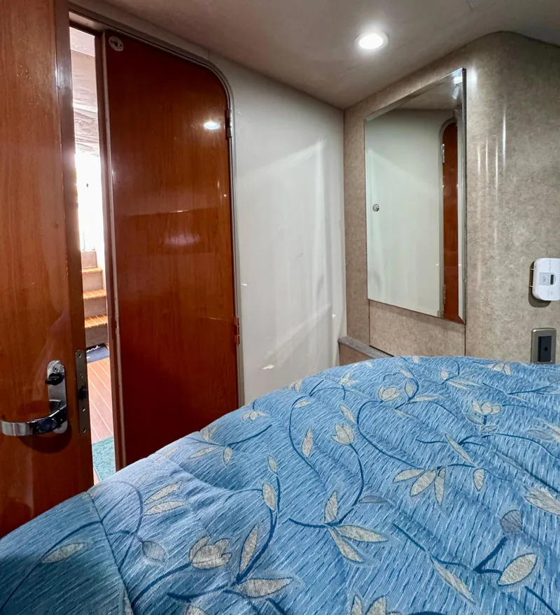 Slide: The Image of Interior cabin of a 2006 Formula 40pc boat with blue floral bedding. - 17