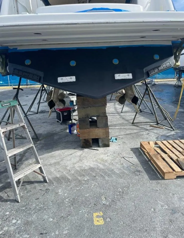 Slide: The Image of 2006 Formula 40pc boat under maintenance, supported by blocks and ladders. - 40