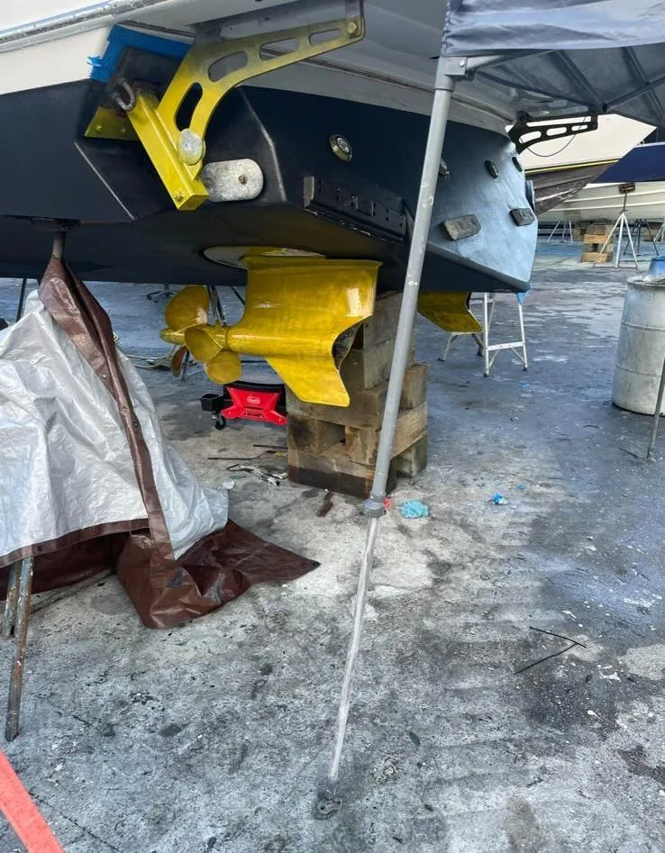 Slide: The Image of 2006 Formula 40pc boat under maintenance, showing yellow propeller and stern drive. - 37