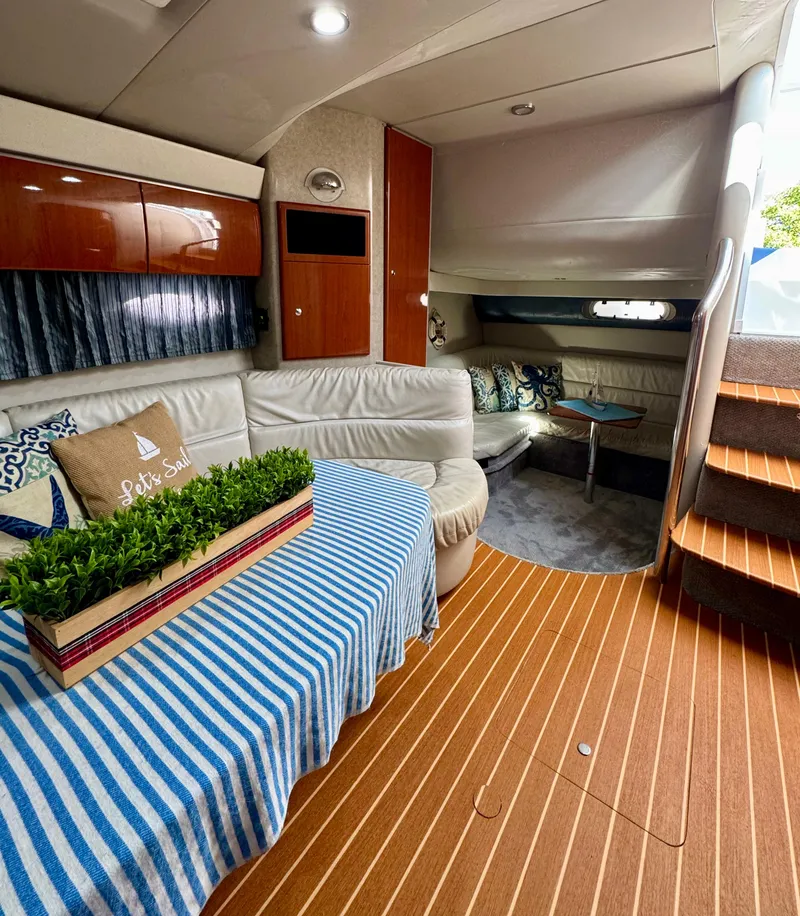 Slide: The Image of Luxurious interior of a 2006 Formula 40pc yacht with elegant seating and striped decor. - 9