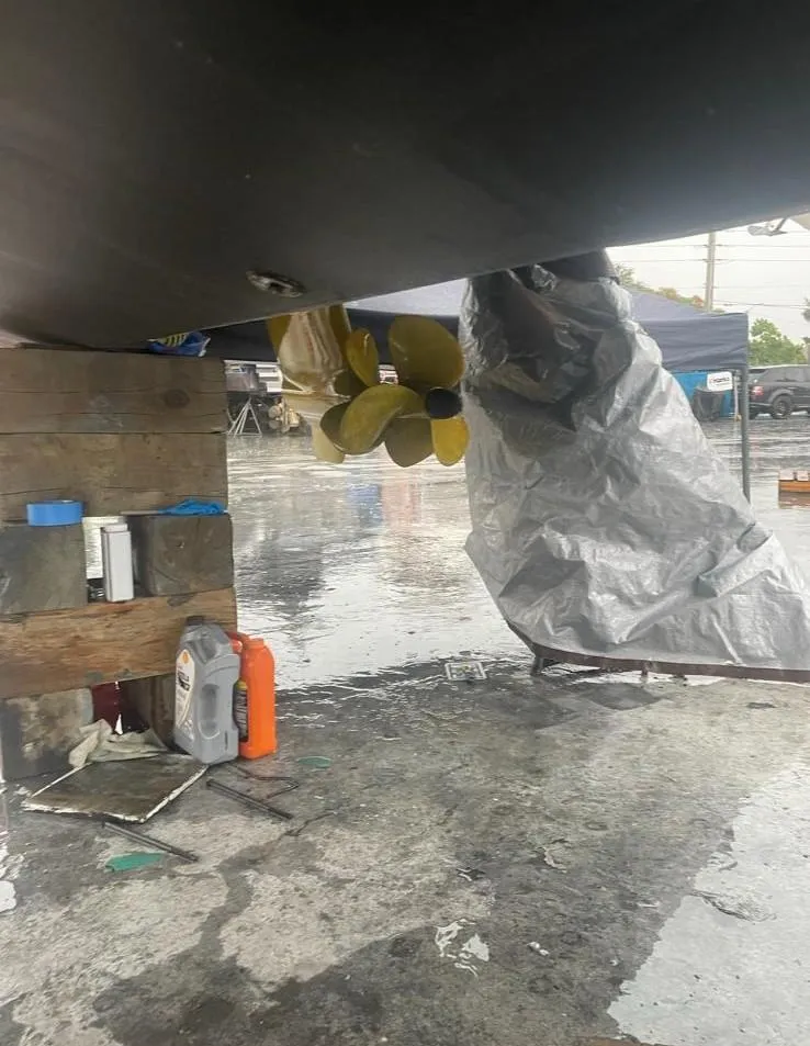 Slide: The Image of Underneath view of a 2006 Formula 40pc boat with visible propeller and maintenance supplies. - 38