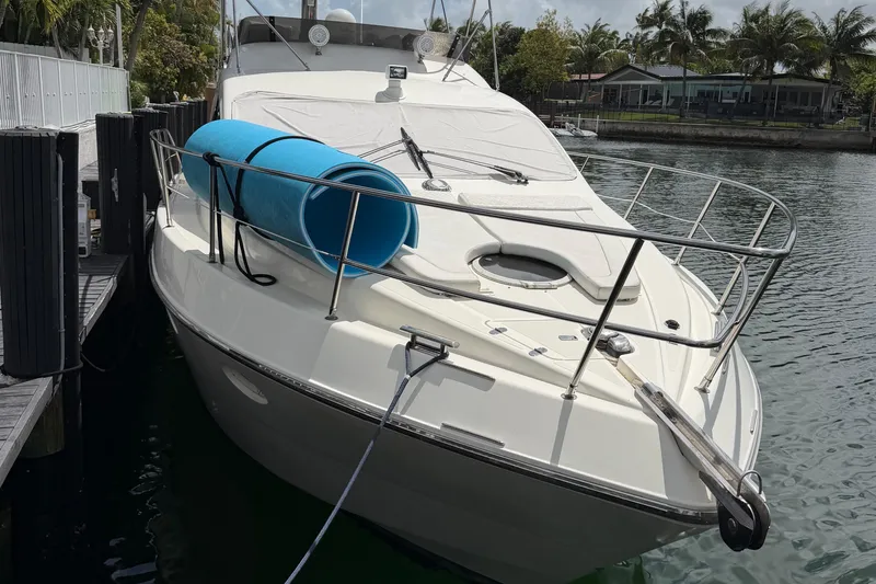 Slide: The Image of 2004 Azimut 39E yacht docked by the water with blue floatation device. - 2