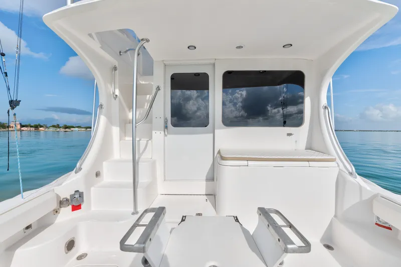 Slide: The Image of 2005 Luhrs 41 Convertible yacht cockpit with seating, steps, and ocean view. - 27
