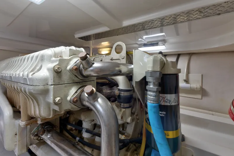 Slide: The Image of Engine compartment of a 2005 Luhrs 41 Convertible boat, showcasing mechanical components. - 34