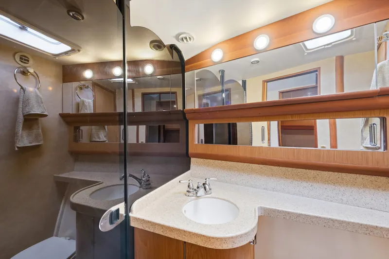 Slide: The Image of Luxurious bathroom in 2005 Luhrs 41 Convertible yacht with modern fixtures and ample lighting. - 18