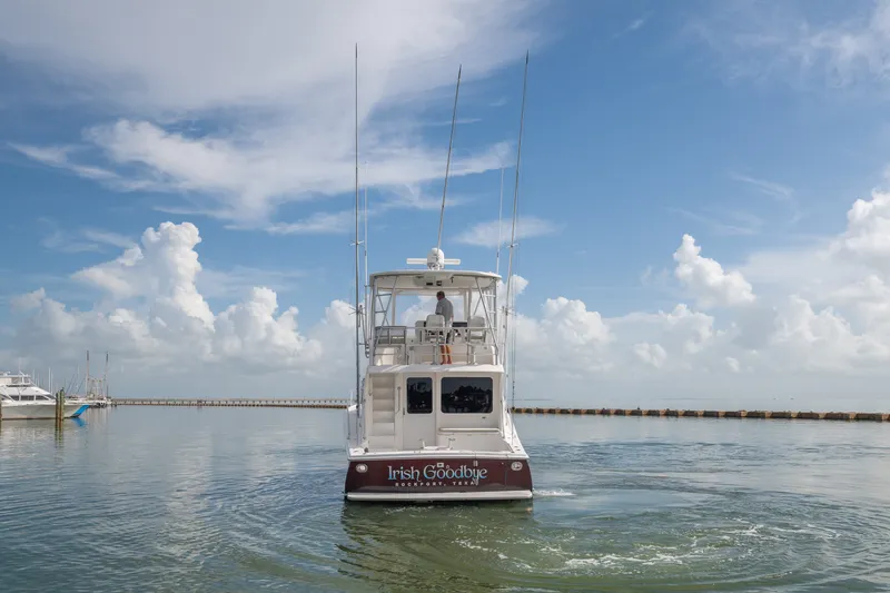 Slide: The Image of 2005 Luhrs 41 Convertible yacht on calm water under a blue sky. - 4