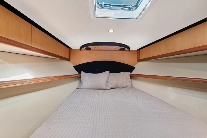 Slide: The Image of Luxurious cabin interior of 2005 Luhrs 41 Convertible yacht with cozy bedding. - 15