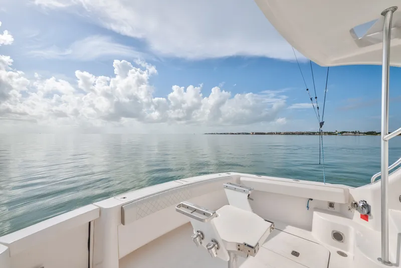 Slide: The Image of 2005 Luhrs 41 Convertible boat deck with ocean view under a cloudy sky. - 29