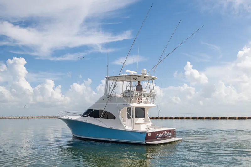 Slide: The Image of 2005 Luhrs 41 Convertible yacht on calm water under a clear blue sky. - 3