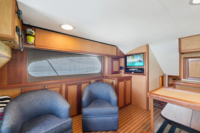 Slide: The Image of Interior of 2005 Luhrs 41 Convertible yacht with wood paneling and blue chairs. - 8