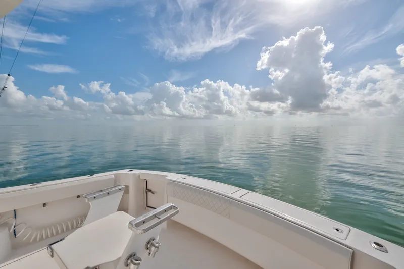 Slide: The Image of 2005 Luhrs 41 Convertible boat on calm ocean under a bright, cloudy sky. - 30