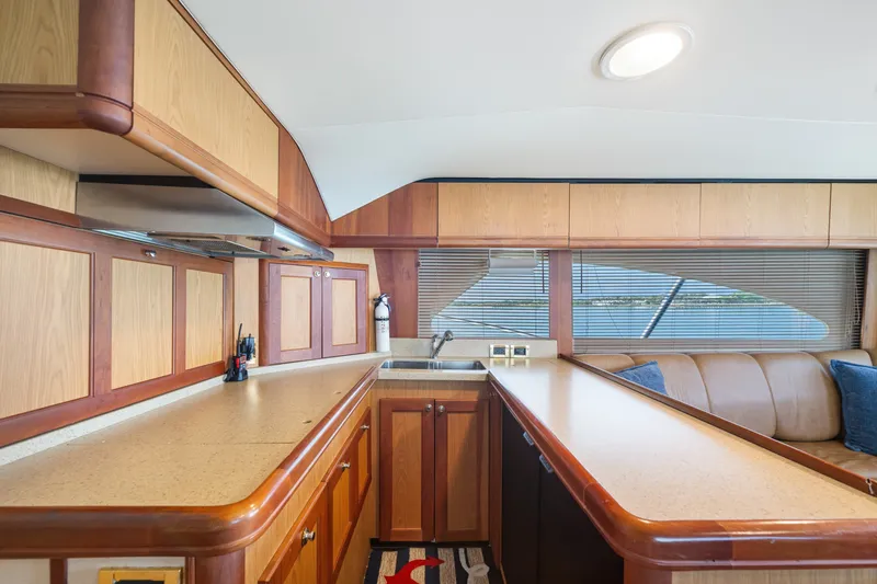 Slide: The Image of Luxurious 2005 Luhrs 41 Convertible yacht interior with spacious kitchen and elegant wood cabinetry. - 12