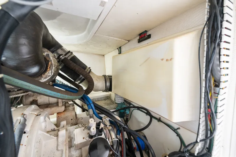 Slide: The Image of Engine room of 2005 Luhrs 41 Convertible boat, showcasing hoses and wiring. - 36