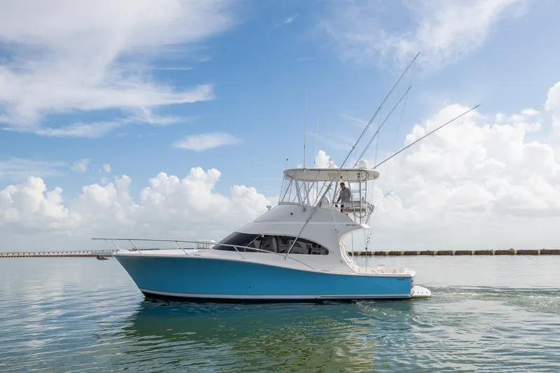 The Image of 2005 Luhrs 41 Convertible yacht cruising on calm waters under a clear sky. - 0