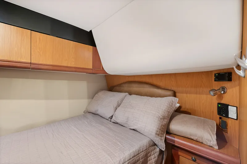 Slide: The Image of Luxurious cabin interior of 2005 Luhrs 41 Convertible yacht with cozy bedding. - 19