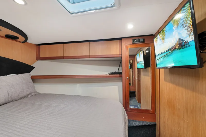 Slide: The Image of Luxurious cabin interior of 2005 Luhrs 41 Convertible yacht with TV and skylight. - 16