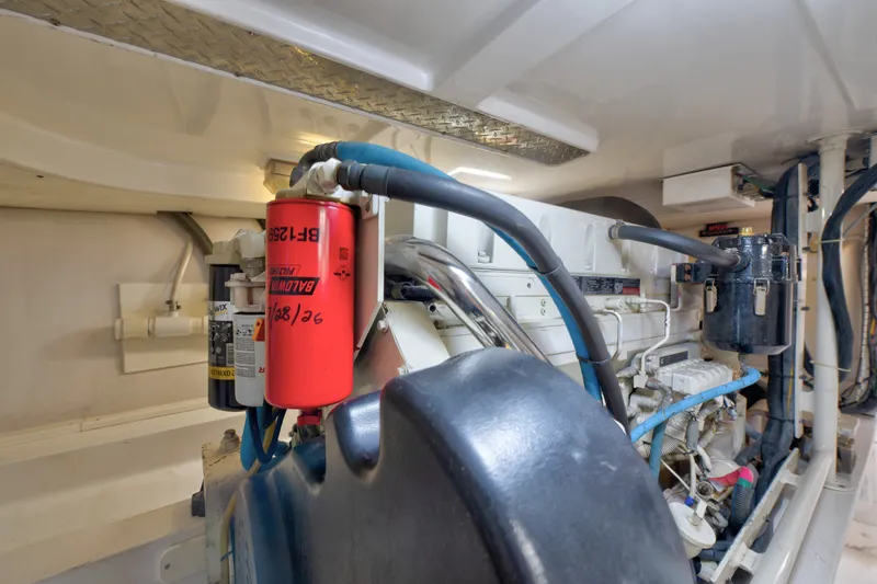Slide: The Image of Engine room of 2005 Luhrs 41 Convertible boat with visible filters and hoses. - 33