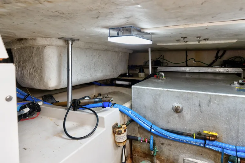 Slide: The Image of Engine room of a 2005 Luhrs 41 Convertible boat, showcasing mechanical components and wiring. - 38