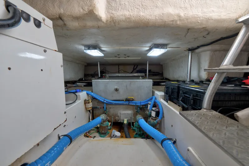 Slide: The Image of Engine room of 2005 Luhrs 41 Convertible boat with visible blue hoses and equipment. - 37