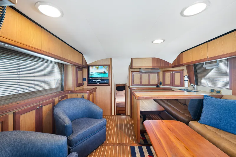 Slide: The Image of Luxurious interior of 2005 Luhrs 41 Convertible yacht with wood finishes and cozy seating. - 6
