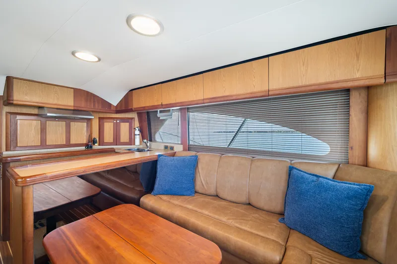 Slide: The Image of Interior of 2005 Luhrs 41 Convertible yacht with wood cabinetry and leather seating. - 7