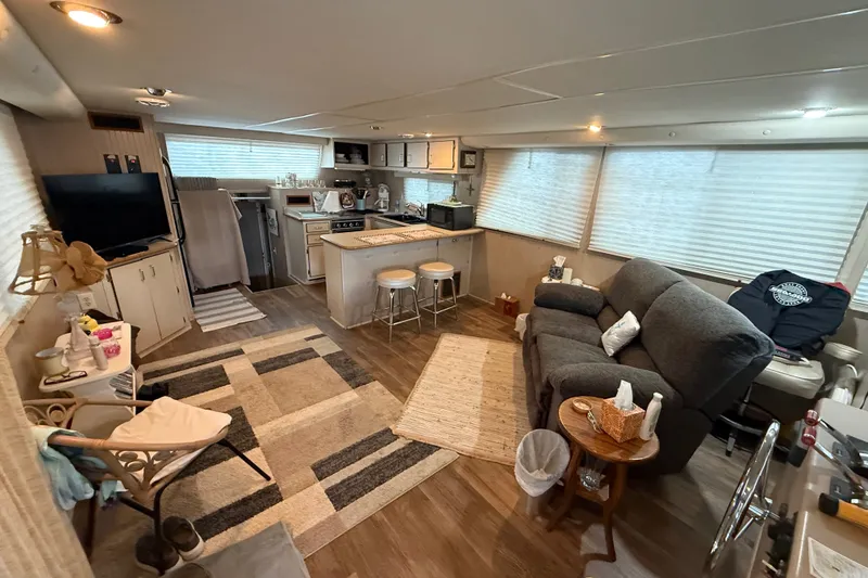 Slide: The Image of Cozy interior of a 2003 Gibson 5500 SERIES houseboat with kitchen and living area. - 1