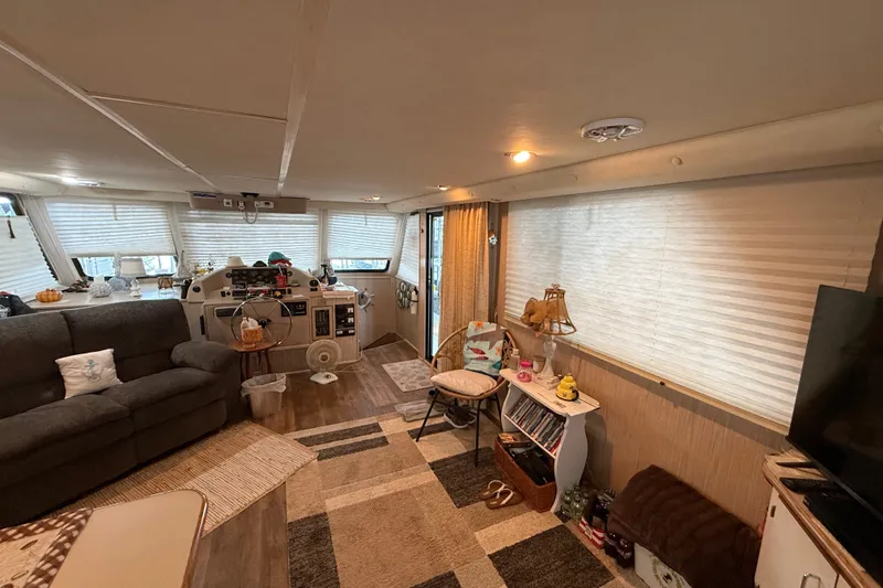Slide: The Image of Interior of a 2003 Gibson 5500 SERIES houseboat with cozy living area and helm. - 5