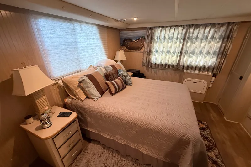 Slide: The Image of Cozy bedroom interior in a 2003 Gibson 5500 SERIES, featuring a neatly made bed and soft lighting. - 7