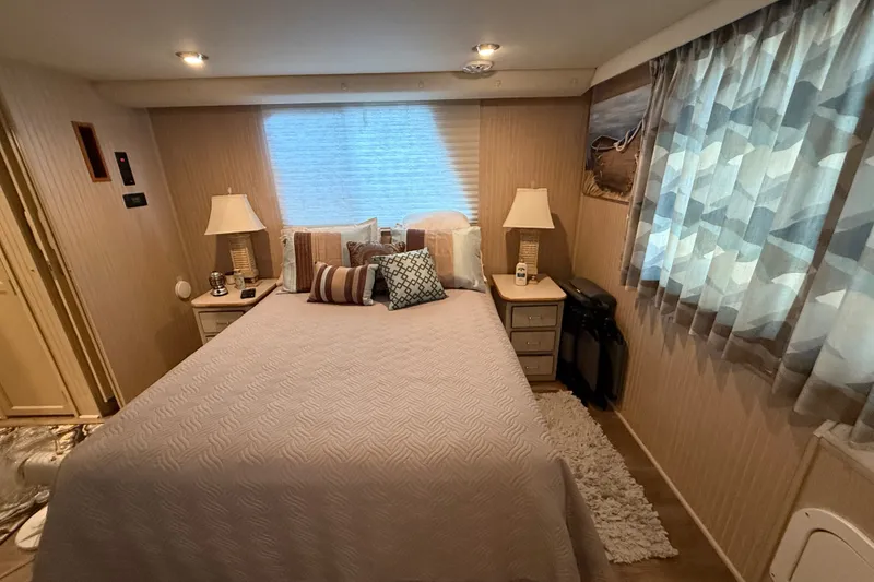 Slide: The Image of Cozy bedroom in a 2003 Gibson 5500 SERIES boat with elegant decor and soft lighting. - 8