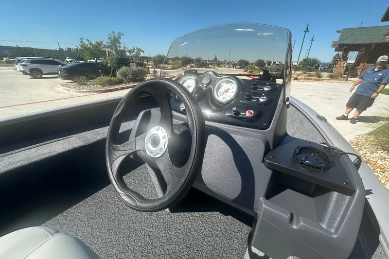 Slide: The Image of Steering console of 2027 Tracker Super Guide V-16 SC boat, featuring gauges and controls. - 17