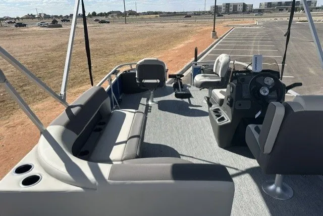 Slide: The Image of 2027 Sun Tracker Bass Buggy 18 DLX pontoon boat interior with seating and steering console. - 14