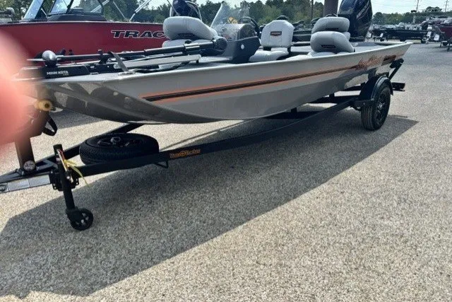 Slide: The Image of 2027 Tracker Bass Tracker Classic Limited boat on trailer, parked outdoors. - 43
