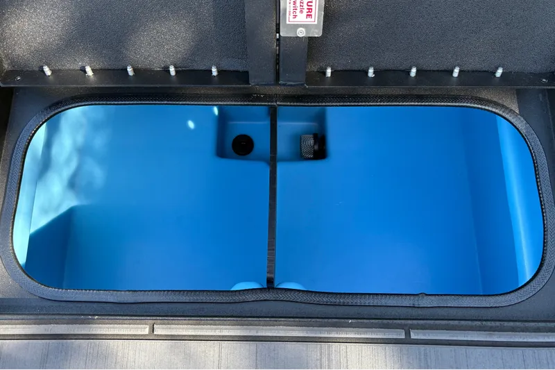 Slide: The Image of Open storage compartment in 2027 Tracker Savage 215 boat. - 29