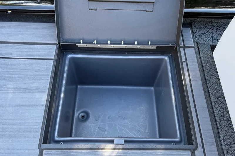 Slide: The Image of Open storage compartment on 2027 Tracker Savage 215 boat deck. - 34