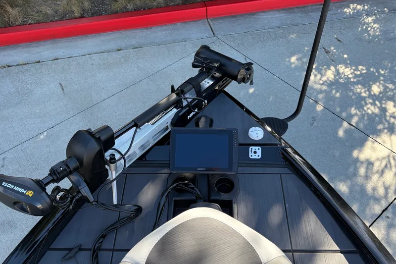 Slide: The Image of 2027 Tracker Savage 215 boat dashboard with advanced navigation system and trolling motor. - 18