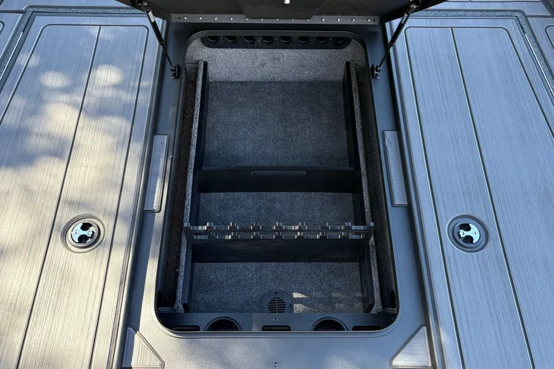Slide: The Image of Open storage compartment on 2027 Tracker Savage 215 boat deck. - 27