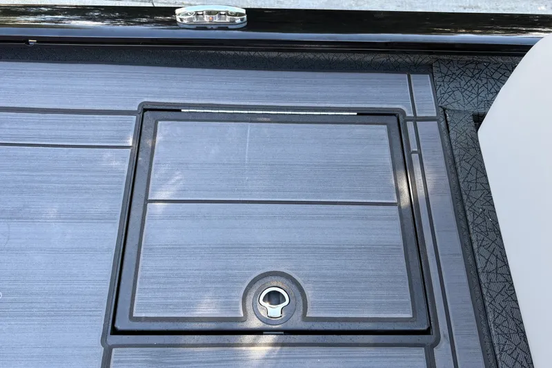 Slide: The Image of Deck hatch of 2027 Tracker Savage 215 boat, featuring sleek design and secure latch. - 33