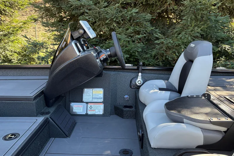 Slide: The Image of Interior of 2027 Tracker Savage 215 boat with steering console and seating. - 23